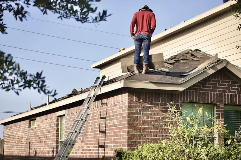 Professional roofer working on a residential roof in Maineville